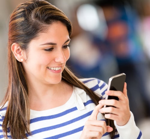 Woman sending a text from her mobile phone